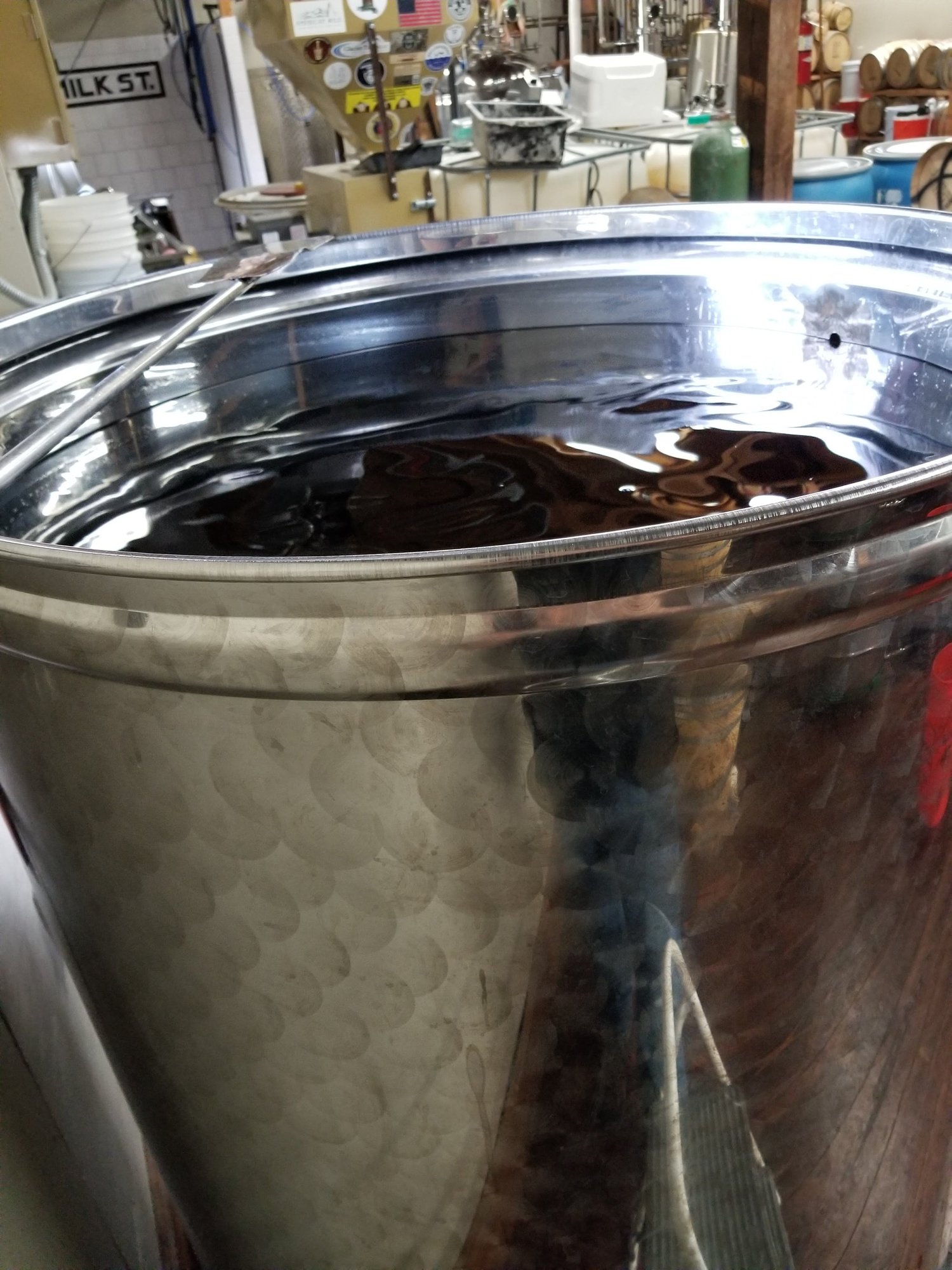 Open stainless tank on the distillery floor.